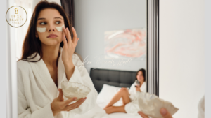 Luxury night skincare routine with a woman applying cream at night.